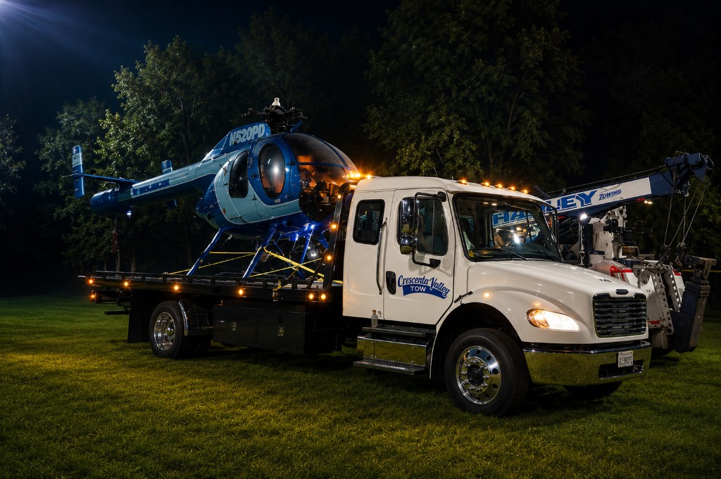 Crescenta Valley tow truck carrying a helicopter at night